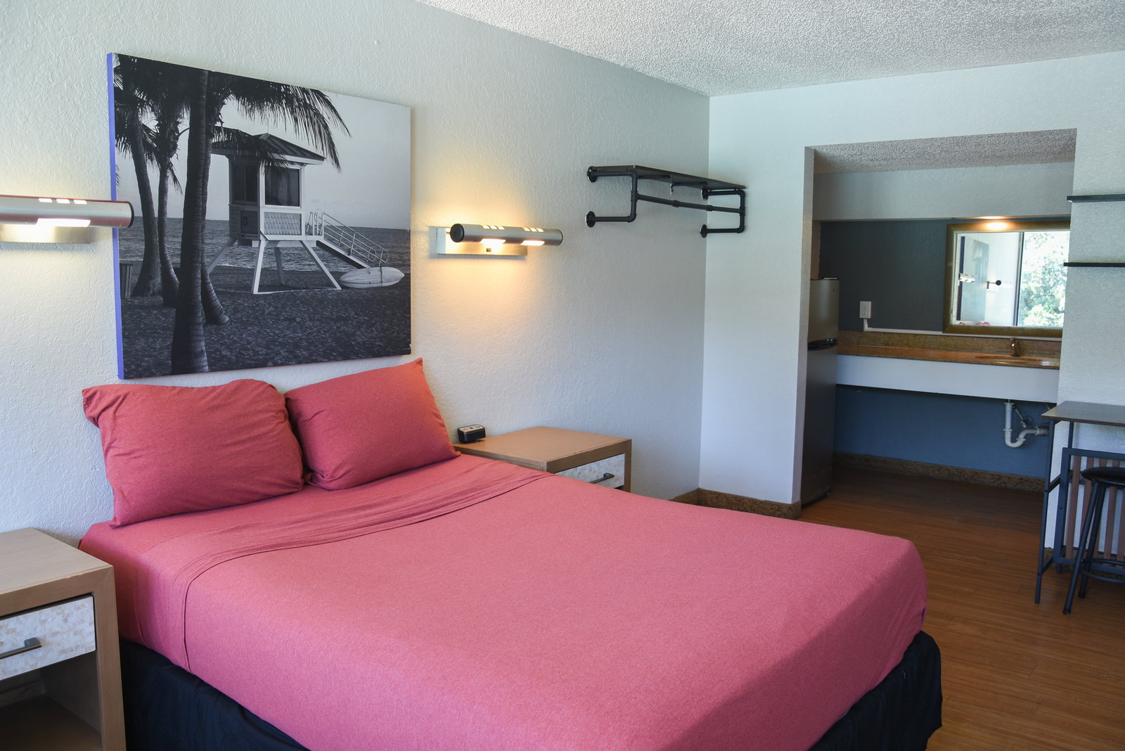 Furnished studio with a queen bed and open shelving