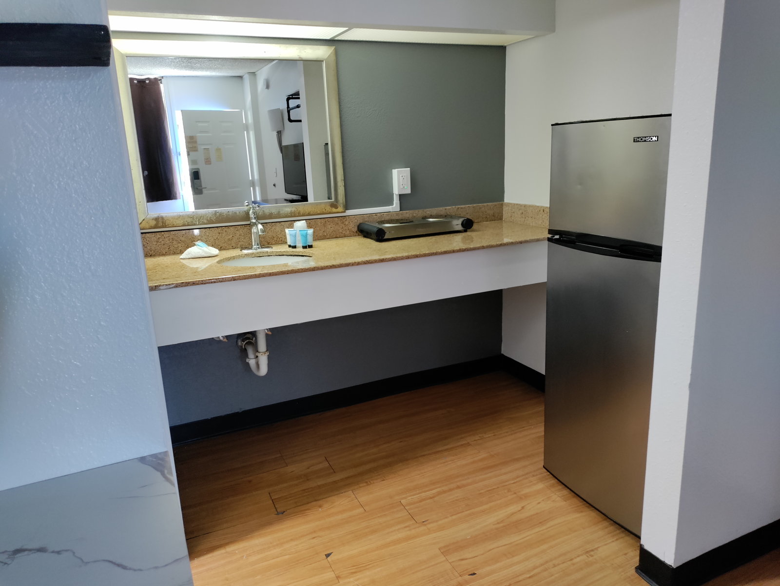 Kitchenette with a full-size refrigerator and vanity