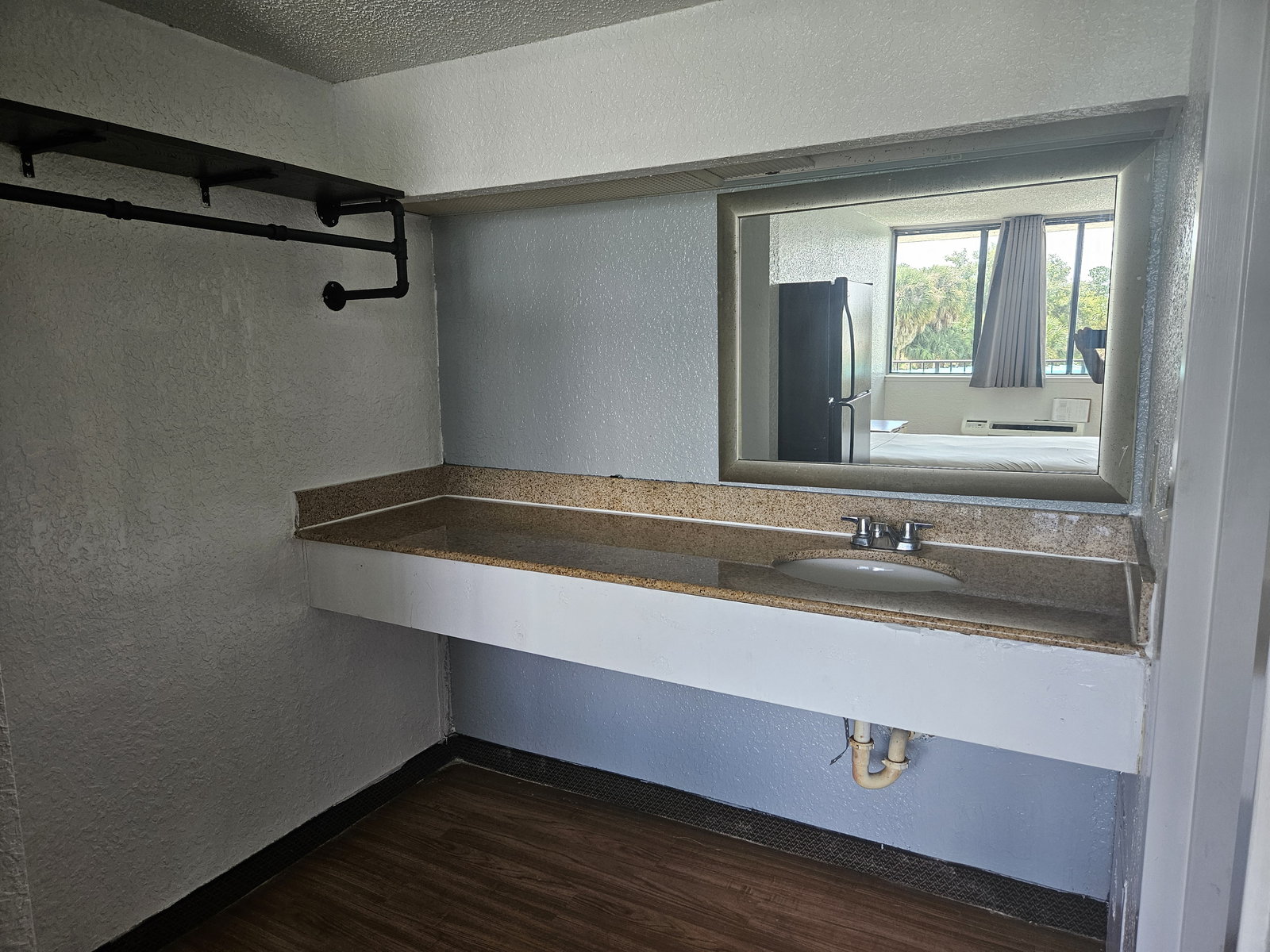 Vanity counter with mirror and open shelving